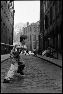 Boy swing a stick for stickball