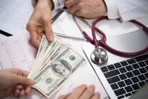 Doctor exchanging money image